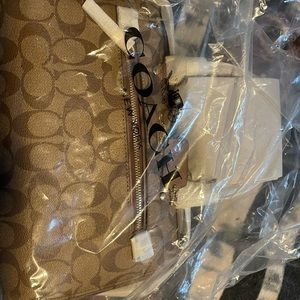 Brand new never used with tags and in bag, Coach saddle bag. $200. Brown & tan.